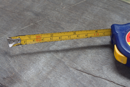 Measure tape on wood backgroundの写真素材