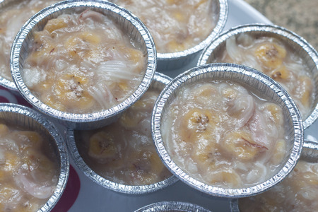 Streamed palm cake, banana dessert in foil cup, Thai traditional cuisineの写真素材