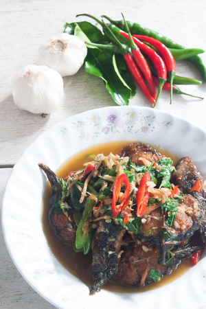 Thai Food Spicy Cat Fish with vegetable on desk (Pla Duk Pad Ped)の写真素材