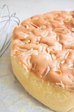 Homemade butter cake with almond stick on topの写真素材