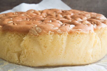 Homemade butter cake with almond stick on topの写真素材