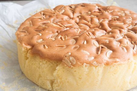 Homemade butter cake with almond stick on topの写真素材