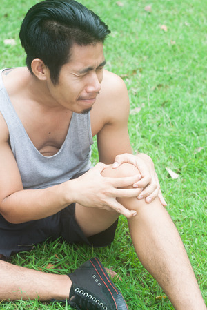 Sport man muscle injury. Runner with muscle pain in kneeの写真素材