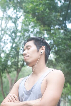 asian man relaxing while listening musicの写真素材