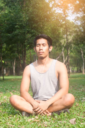 asian man relaxing while listening musicの写真素材