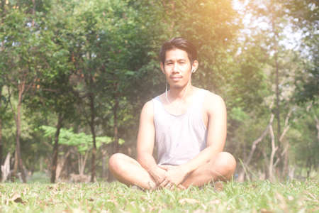 asian man relaxing while listening musicの写真素材