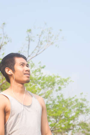 asian man relaxing while listening musicの写真素材
