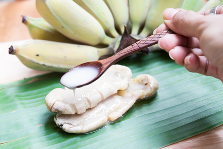 Thai traditional sweet made from banana on banana leafの写真素材