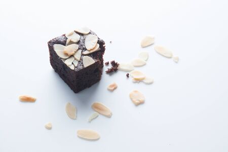 Chocolate brownie, bitten off on white backgroundの写真素材