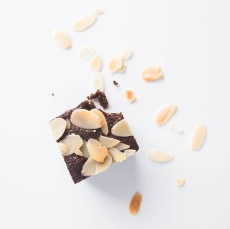 Chocolate brownie, bitten off on white backgroundの写真素材