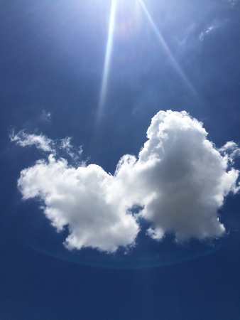 Dark blue sky with clouds and sunの写真素材