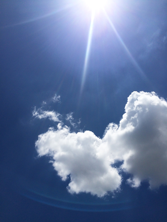 Dark blue sky with clouds and sunの写真素材