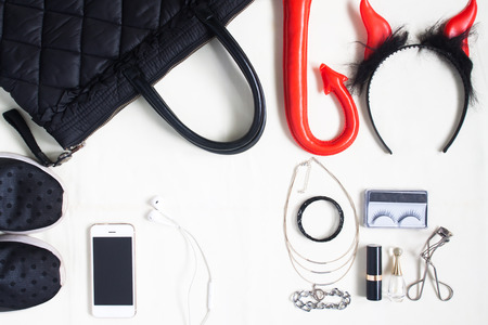 Flat lay photography with Halloween accessories, cosmetics, essential items for woman and smartphone , Overhead view of Halloween accessories items, top viewの写真素材