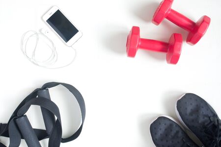 Sport fitness items with smartphone on white background, flat lay, top view, copy spaceの写真素材