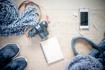 Flat lay photography with empty notebook, cellphone, travel accessories, essential items for woman,...