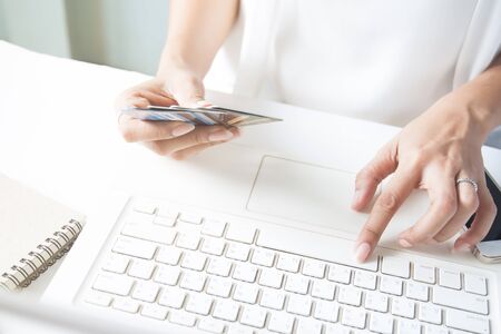 Hands holding credit card and using laptop. Online shoppingの写真素材