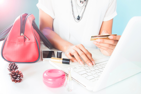 Woman's hands holding credit card and using laptop. Online shoppingの写真素材