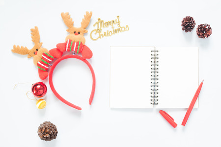 Christmas composition. Christmas decoration, pine cones, notebook and red pen with copy space. Flat lay, top viewの写真素材