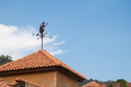 Windmill and witch on the rooftop with blue skyの写真素材