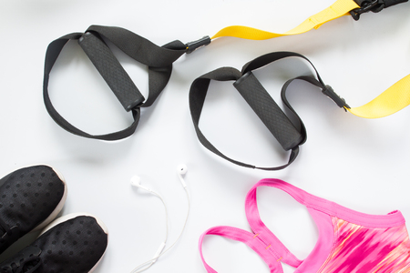 Flat lay of earphone, sneakers and sport equipment on white background. Sport wear, top viewの写真素材