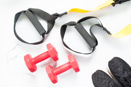 Flat lay of earphone, sneakers and sport equipment on white background. Sport wear, top viewの写真素材
