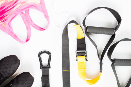 Flat lay of sport equipment, pink sport bra, sneakers on white background. Sport wear, top viewの写真素材