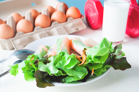 Fresh salad with egg and milk, Healthy menu with red dumbbell, Healthy lifestyle conceptの写真素材