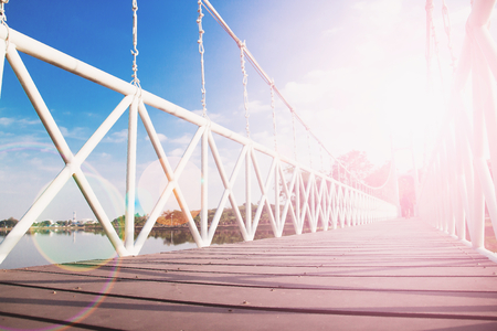 Rope bridge with sunset reflection and blue skyの写真素材