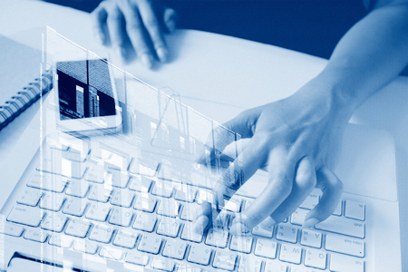 Working woman using laptop and mobile phone with building architecture, Business conceptの写真素材