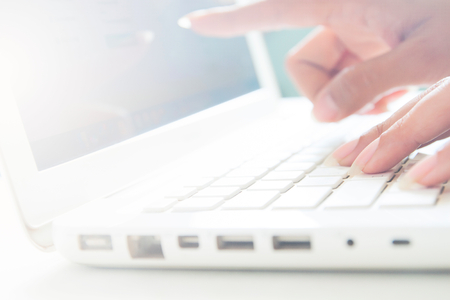 Hand on keyboard and point to screen of laptop, Business concept with copy spaceの写真素材