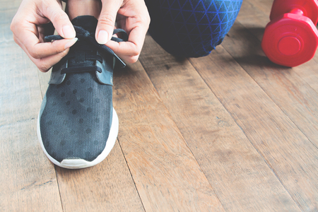 Closeup of woman tying shoelaces, Working out conceptの写真素材