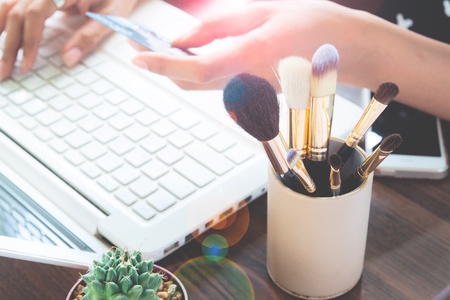 Girl using credit card and laptop computer for online shopping, Beauty and Online shopping conceptの写真素材
