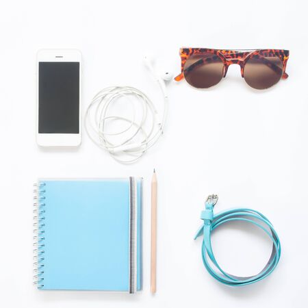 Flat lay of woman accessories in blue color collection with smartphone isolated on white background, Spring summer fashion setの写真素材