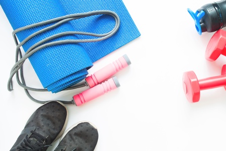 Flat lay of female sport and yoga equipments on white background with copy spaceの写真素材