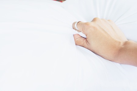 Woman hand having sex on a bed in morning, Hand sign love and sex conceptの写真素材