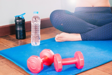 Fitness woman in sport clothing working out at home, Fitness and Healthy lifestyle conceptの写真素材
