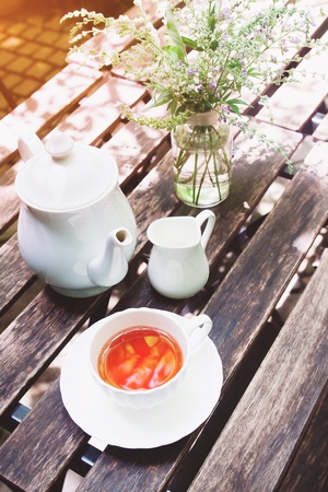 Tea time on wooden table in cottage gardenの写真素材