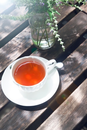 A cup of hot tea on wooden tableの写真素材