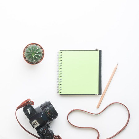 Blank green color notebook and camera on white background, Summer lifestyle conceptの写真素材