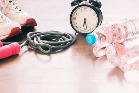 Sport equipments and bottle of water with measuring-tape, Workout and Healthy lifestyleの写真素材