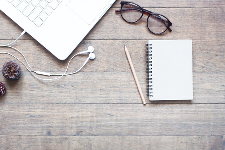 Creative flat lay design of workspace with white laptop on wood tableの写真素材