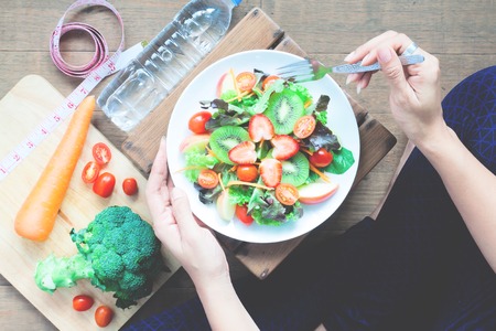 Yoga woman cooking fresh salad, Healthy foodの写真素材