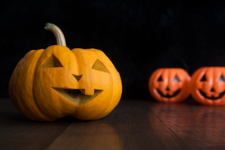 Halloween still life with pumpkins on wooden floor and dark backgroundの写真素材
