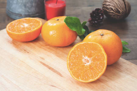 Fresh oranges on wooden table in kitchenの写真素材