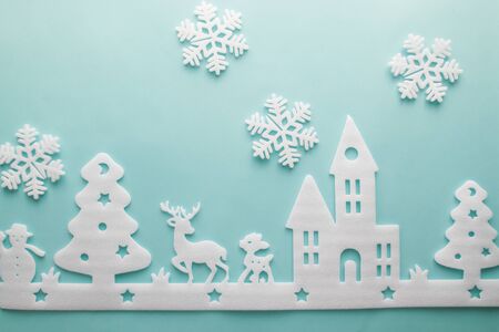 Merry Christmas and Happy New Year. Foam cutter of City with snowflake, art and craft style on pastel color paperの写真素材