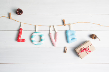 Love alphabets with gift box on vintage white wooden background, Top view love conceptの写真素材
