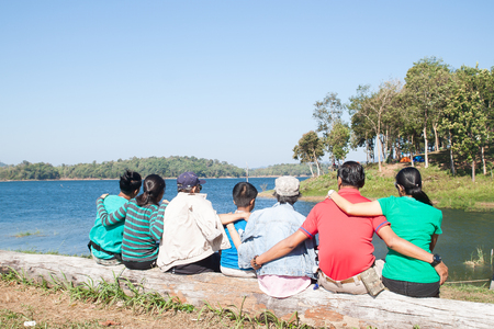 Happy family, Big family variety of generation sitting by the lake and mountain view, Healthy and Travel concept の写真素材
