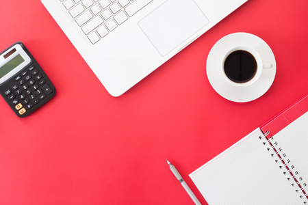 Creative flat lay of Business and Online shopping concept, laptop computer, cup of coffee, calculator and notebook on red color background, Workspace, Online marketingの写真素材