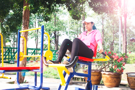 Asian 40s woman exercising with training equipments in the public park, Healthy lifestyle, Beauty conceptの写真素材