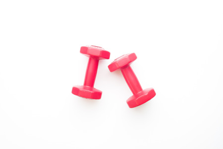 Red color dumbbells isolated on white backgroundの写真素材